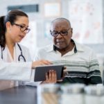 Doctor and patient looking at device